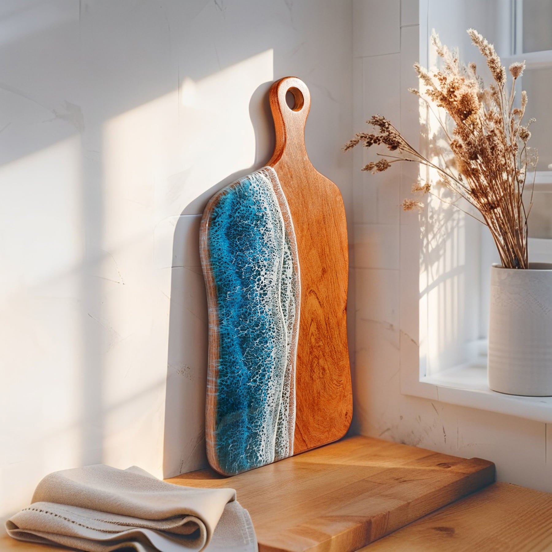 Wooden cutting boards with a blue and white design on a wooden surface with a light background.